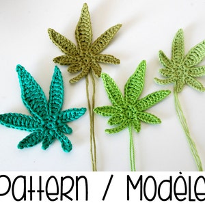 May include: Three crocheted marijuana leaf ornaments in green, light green, and teal.