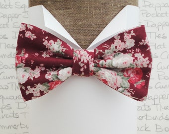 Pre tied floral bow tie, blush pink and sage green on a burgundy background.