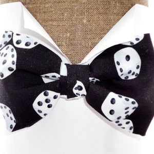 Bow tie, white dice on black, pre tied on an adjustable neck band, will fit neck size up to 20”. Also available in self tie.