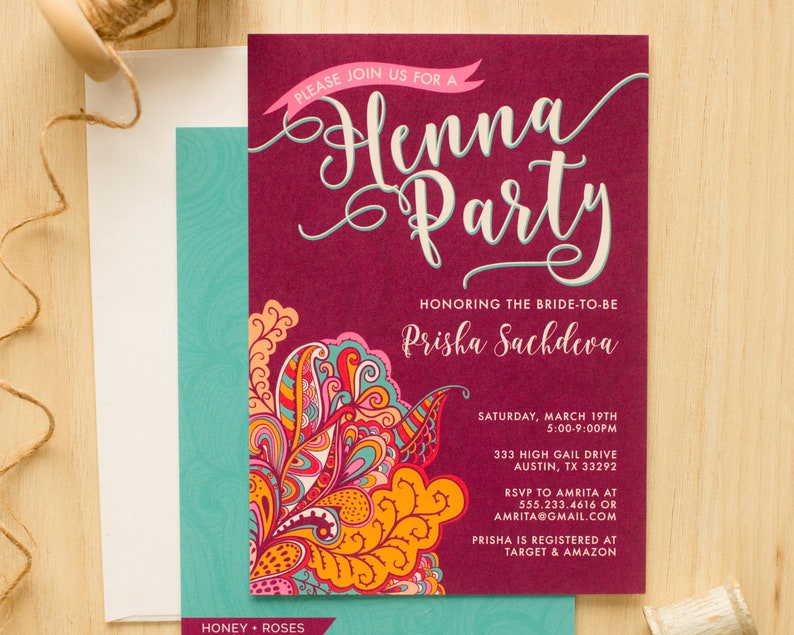 May include: A burgundy invitation with a decorative floral design in shades of orange, pink, blue, and green. The invitation is for a Henna party honoring Prisha Sachdeva, with the date and time of the event, the address, and RSVP information.