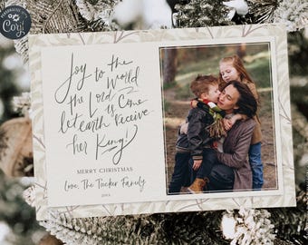 May include: Christmas card with a family photo and holiday message. The card features a photo of a mother and two children, with the text "Joy to the World, the Lord is Come, let earth receive her King!" and "Merry Christmas".