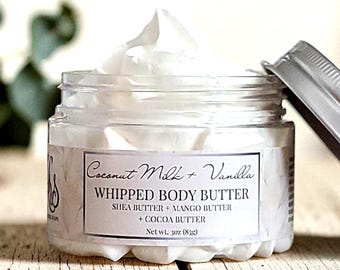 May include: A clear plastic jar filled with white whipped body butter, topped with a silver lid. The label reads Coconut Milk + Vanilla, WHIPPED BODY BUTTER, SHEA BUTTER + MANGO BUTTER + COCOA BUTTER, and Net wt. 3oz (85g).