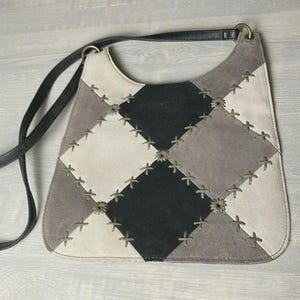 May include: A set of three ceramic nesting bowls. The largest bowl is light blue, the medium bowl is green, and the smallest is yellow. Each bowl has a smooth, glossy finish and a simple, modern design.