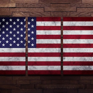 May include: A distressed American flag is displayed on a wooden wall. The flag is divided into three sections, each showing the stars and stripes.