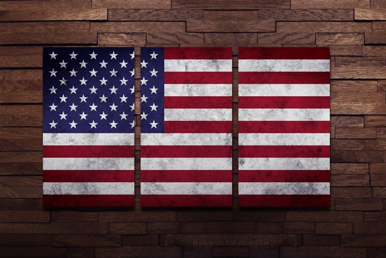 May include: A distressed American flag is displayed on a wooden wall. The flag is divided into three sections, each showing the stars and stripes.