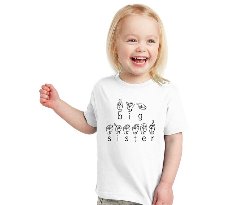 May include: A white t-shirt with the words "I am a big sister" spelled out in British Sign Language.