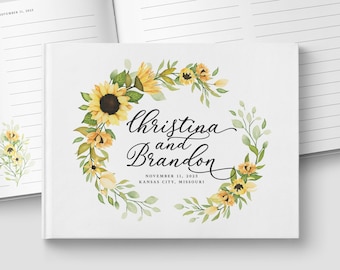 May include: A white guest book with a sunflower wreath design. The text reads "Christina and Brandon" with the date "November 11, 2023" and the location "Kansas City, Missouri".