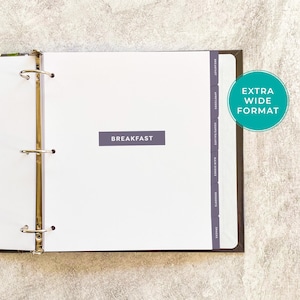 May include: An open binder with white pages and metal rings. The word "BREAKFAST" is printed on a gray rectangle. Vertical tabs on the right side are labeled "APPETIZERS", "SOUPS/SALADS", "MAIN DISHES", "DESSERTS", and "SNACKS". A green circle reads "EXTRA WIDE FORMAT".