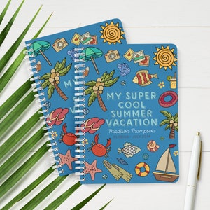 May include: A blue spiral bound notebook with a summer vacation theme. The cover features illustrations of palm trees, flip flops, seashells, fish, and a sailboat. The text on the cover reads "My Super Cool Summer Vacation" and "Madison Thompson, Florida, July 2019".