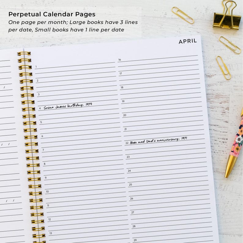 May include: Open spiral-bound perpetual calendar with lined pages. The word "APRIL" is at the top right. Text on the page includes dates and handwritten notes. Gold-colored paper clips and a floral pen are visible.