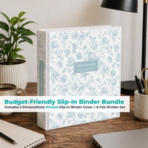 May include: A white binder with a floral pattern in light blue. The binder has a label that reads "GRACIE JAMESON NURSING | FIRST YEAR". The text "Budget-Friendly Slip-In Binder Bundle" is also visible.