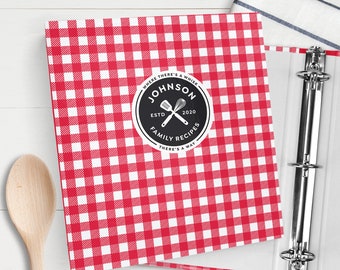 May include: Red and white checkered binder with a black and white logo that says "Johnson Family Recipes" with a whisk and spatula crossed in the center. The logo also says "Where there's a whisk, there's a way" and "Estd 2020".