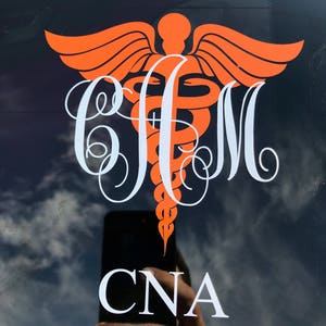 May include: Orange medical caduceus symbol with white wings and a snake wrapped around a staff. The letters "CJM" are in a white cursive font below the symbol. The words "CNA" are in white block letters below the monogram.
