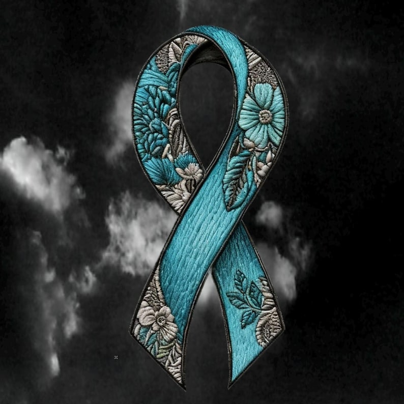 May include: A teal awareness ribbon patch featuring intricate embroidery of various floral patterns. The ribbon has a textured appearance with detailed stitching in shades of teal, light blue, and silver, creating a layered botanical design.