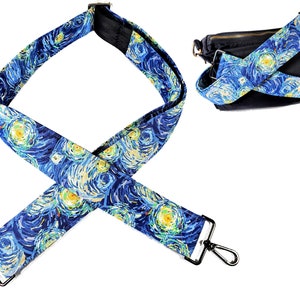 May include: A bag strap with a blue and yellow 'Starry Night' design, complete with silver-coloured metal clasps. The strap is shown on its own and attached to a black bag. The strap's design is reminiscent of Van Gogh's painting.