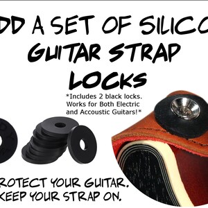 May include: A set of black silicone guitar strap locks. The image shows two guitar strap locks, a close-up of a guitar strap lock on a guitar, and a stack of silicone strap locks. The text on the image reads: "ADD A SET OF SILICONE GUITAR STRAP LOCKS *Includes 2 black locks. Works for Both Electric and Acoustic Guitars!* PROTECT YOUR GUITAR. KEEP YOUR STRAP ON."