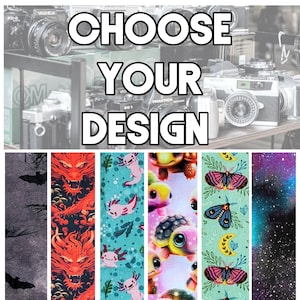 May include: Five different designs for a phone case. The designs include a black and white bat pattern, a red dragon pattern, a blue and green axolotl pattern, a pink and white turtle pattern, and a green and yellow moth pattern.
