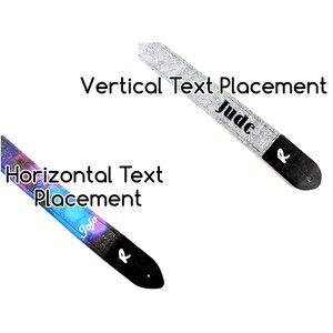May include: Two guitar straps with different text placement options. One strap has a galaxy print with the name "Jojo" written horizontally. The other strap has a white and black abstract pattern with the name "Jude" written vertically.