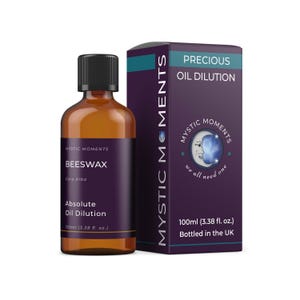 May include: A brown glass bottle with a black cap and a purple label that reads "BEESWAX" and "Absolute Oil Dilution." Beside it is a purple box with "PRECIOUS OIL DILUTION" and "MYSTIC MOMENTS" printed on it. The bottle contains 100ml of product.