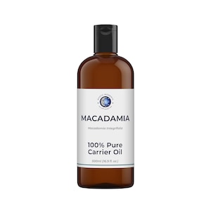 May include: A brown plastic bottle with a black flip-top cap containing 500ml (16.9 fl. oz.) of 100% Pure Macadamia Carrier Oil. The white label features the text Mystic Moments, Macadamia, Macadamia Integrifolia, and 100% Pure Carrier Oil.