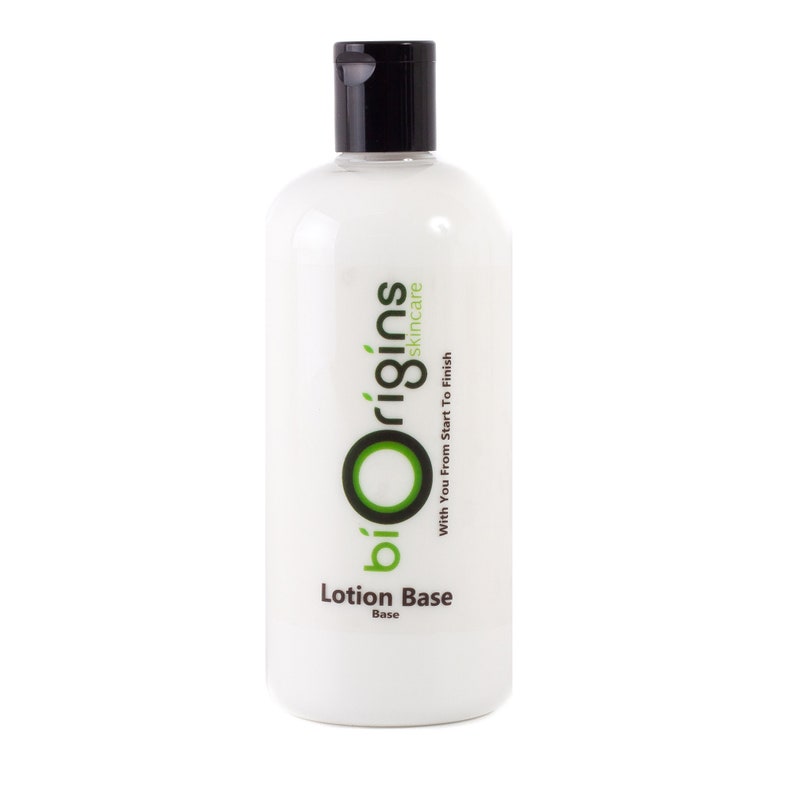 May include: A white lotion bottle with a black cap. The bottle has the text "biOrigins skincare" in green and black, with the words "Lotion Base" below. The bottle is filled with a white liquid.