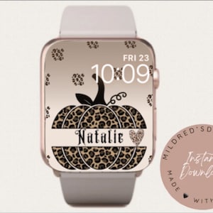 May include: A digital watch face with a leopard print pumpkin design. The watch face is personalized with the name "Natalie" and the date "FRI 23". The time is displayed as "10:09".
