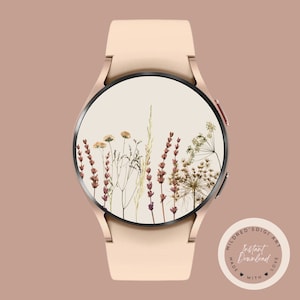 May include: A rose gold smartwatch with a white face and a floral design. The watch face features dried flowers and grasses in shades of brown, beige, and white. The watch band is a light pink silicone.