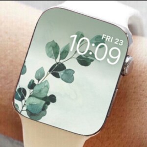 May include: White smartwatch with a green leafy pattern on the face. The time is 10:09 and the date is FRI 23.