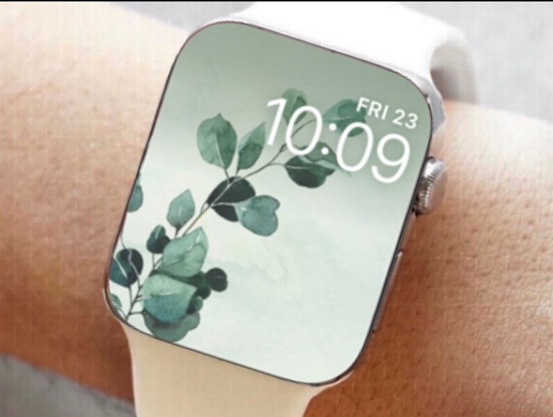 May include: White smartwatch with a green leafy pattern on the face. The time is 10:09 and the date is FRI 23.