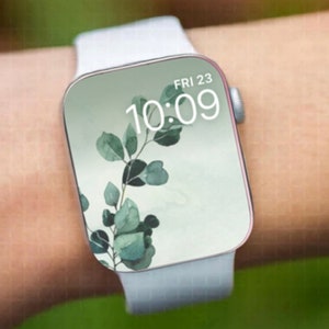 May include: A white Apple Watch with a white band, displaying a green leafy branch design and the time 10:09, with the date FRI 23.
