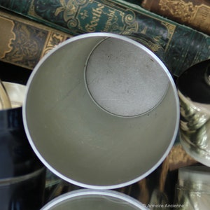 K&ouml;nnte beinhalten: Ein silberner Cocktail-Shaker aus Metall mit einer glatten, gl&auml;nzenden Oberfl&auml;che. Der Shaker ist offen und das Innere ist sichtbar.