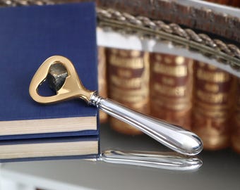 Abridor de tapas Wilkens con mango de plata 800 y detalles chapados en oro