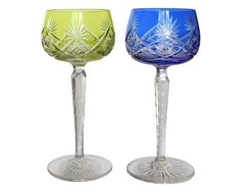 May include: Two crystal wine glasses with cut glass designs. One glass is green and the other is blue.