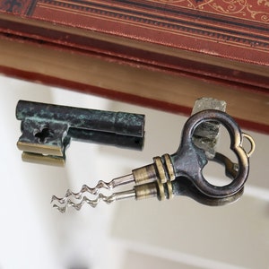May include: A vintage-style bottle opener with a key-shaped handle and a corkscrew. The opener is made of metal and has a green patina finish.
