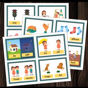 May include: A set of flashcards with colorful illustrations and words for opposites. The words include: stop, day, night, dry, wet, different, friends, enemies, hungry, and full.