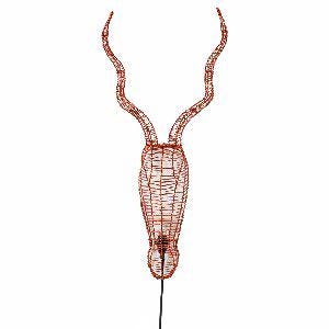 May include: A copper wire sculpture of an antelope head with long, curved horns. The sculpture is a wall hanging and has a cord coming out of the bottom.
