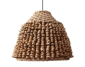 May include: A woven pendant light fixture with a conical shade. The shade is made of natural-colored, tightly woven material, creating a textured surface. The light hangs from a black cord against a white background.