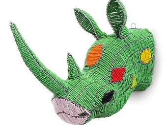 May include: A green beaded rhinoceros head sculpture with colorful accents. The sculpture is made of small beads and wire, and features a pink nose, orange and yellow spots, and red eyes.
