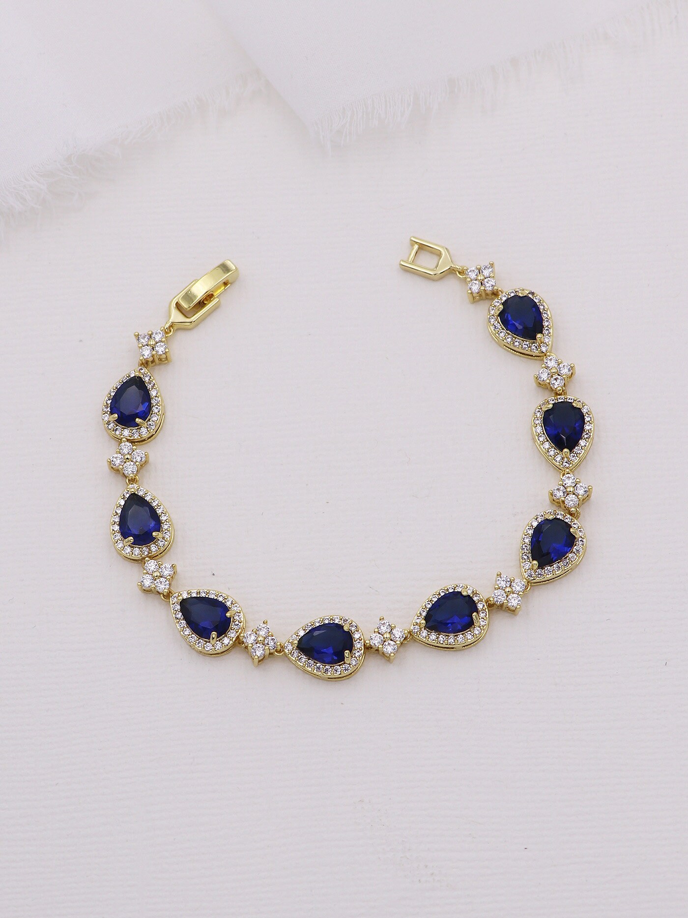 Gold bracelet with blue stones clearance
