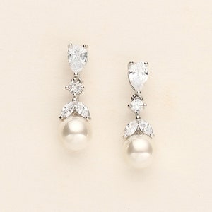 a pair of white pearl and crystal earrings