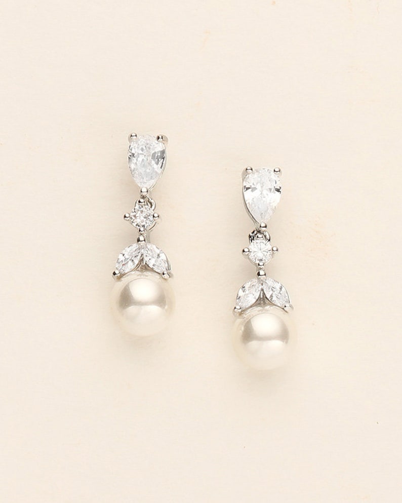 a pair of white pearl and crystal earrings