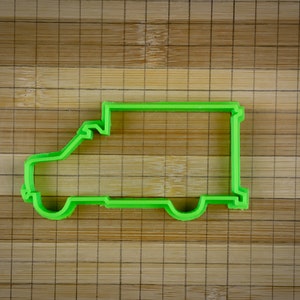 May include: Green plastic cookie cutter shaped like a delivery van.