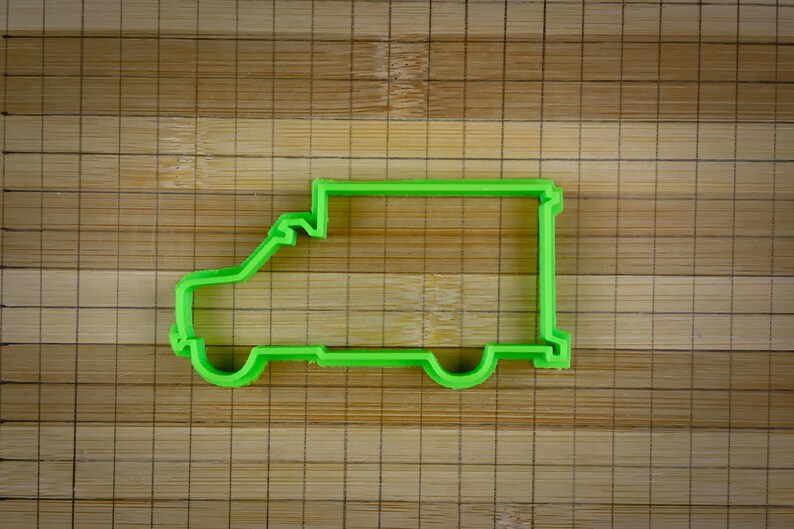 May include: Green plastic cookie cutter shaped like a delivery van.
