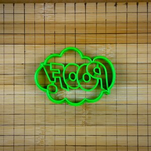 May include: Green plastic cookie cutter shaped like a speech bubble with the word "FOOD" inside.