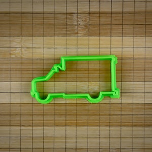 May include: Green plastic cookie cutter shaped like a delivery van.
