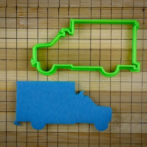 May include: A green plastic cookie cutter shaped like a delivery van, and a blue felt delivery van.