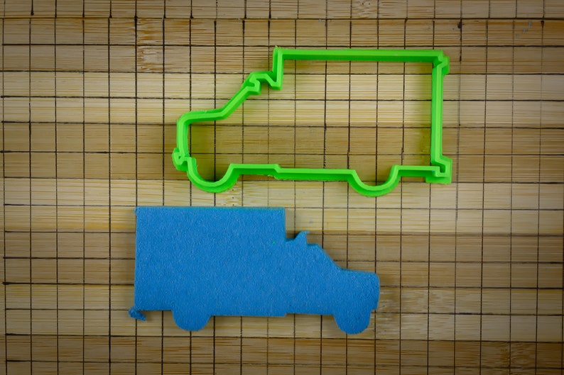 May include: A green plastic cookie cutter shaped like a delivery van, and a blue felt delivery van.