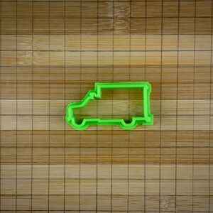 May include: Green plastic cookie cutter shaped like a delivery van.