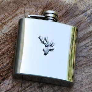 May include: A silver stainless steel hip flask with a stag head design.