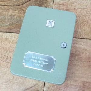 May include: A green metal key safe with a silver plaque that reads "Your Message Engraved Here For Free".